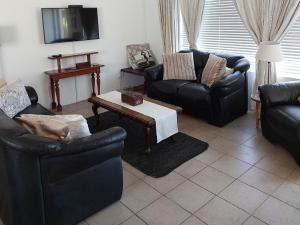 a living room with two couches and a coffee table at Lieflappie Seaview Stilbaai 400m to the beach in Stilbaai