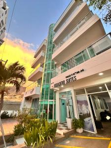 a building with a sign that reads hilton suites at Hotel Rodadero Suites By SGH in Santa Marta