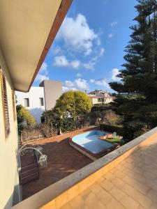 a view of a swimming pool from a house at Villa Sunrise in Casteldaccia
