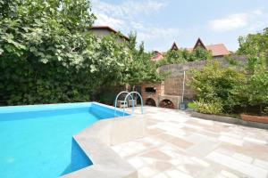 a swimming pool in a yard next to a house at Villa in the center of Yerevan in Yerevan