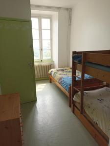 a bedroom with two bunk beds and a window at Chambres d'Hôtes Le Clos Ambels in Ambialet +9 photos