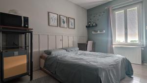 a bedroom with a bed and a television at Chambre studio in Sublaines