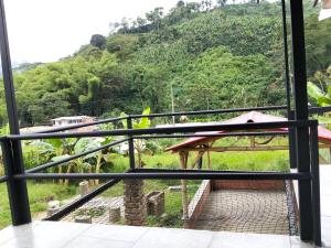 a balcony with a view of a mountain at Las Margaritas Cabaña in Chinchiná +3 photos