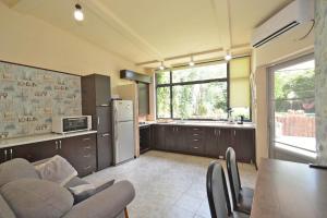 a kitchen with a couch and a table and a refrigerator at Villa in the center of Yerevan in Yerevan