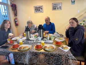 a group of people sitting around a table eating food at Kaypi Yireh in Cabanaconde