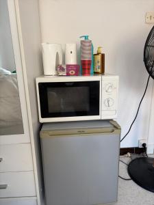 a microwave sitting on top of a refrigerator at residence st marguerite in Antibes