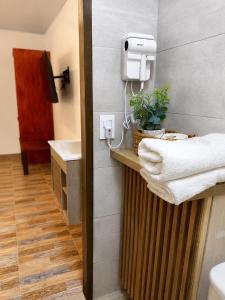 a bathroom with a sink and a towel rack at Eco-Hotel Palma É Coco in San Andrés +35 photos