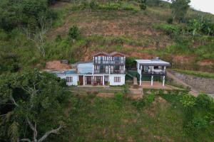 an aerial view of a house on a hill at O'Neill's Cottage in Dikkapitiya
