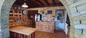 a kitchen with a table and a refrigerator at Le Taconet in Le Praz de Lys