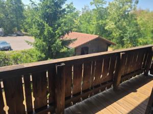 a wooden bridge with a house in the background at Ferienhaus John in Saarwellingen
