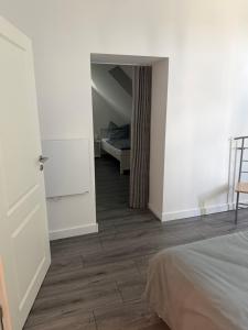 a bedroom with a bed and a room with a door at Ferienwohnung Calluna in Faßberg