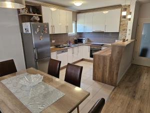a kitchen with a table and a refrigerator at Rooms Mario in Međugorje