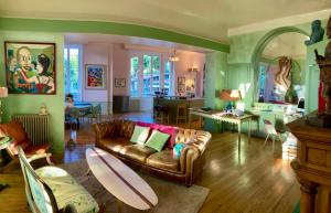 a living room with a couch with a surfboard on it at Villa AJNA Bayonne in Bayonne