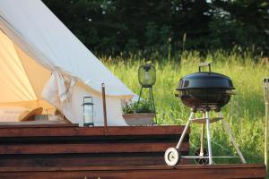 a grill sitting on a table next to a tent at Vrhnika hill in Vrhnika