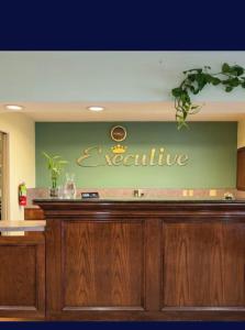 a restaurant counter with a sign on the wall at EXECUTIVE INN & SUITES HIGHWAy US 59 in Lufkin