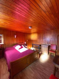 a bedroom with a large bed and a wooden ceiling at Le Mazot in Veyrier-du-Lac