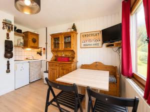 a kitchen with a wooden table and two chairs at Studio charmant pour 4 pers avec parking à Notre-Dame-de-Bellecombe - FR-1-505-49 in Notre-Dame-de-Bellecombe