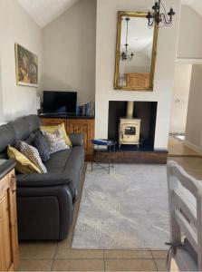 a living room with a couch and a tv at Cottage in the Dublin mountain in Dublin