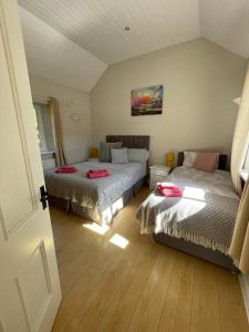 a bedroom with two beds and a couch at Cottage in the Dublin mountain in Dublin