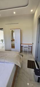 a bedroom with a bed and a table and a mirror at Cherry Bloom in Chikmagalūr