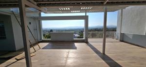 an empty balcony with a view of the mountains at Cherry Bloom in Chikmagalūr