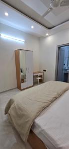 a bedroom with a large bed and a table at Cherry Bloom in Chikmagalūr +4 photos