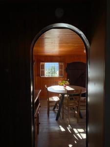 a dining room with a table and a window at Le Mazot in Veyrier-du-Lac +2 photos