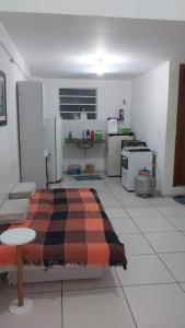 a kitchen with a bed in the middle of a room at Flat Shopping Amarração N - 129 in Luis Correia