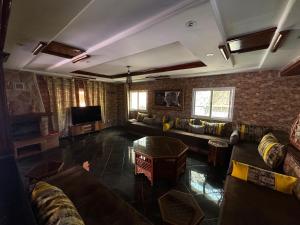 a large living room with couches and a tv at Dar Idurar in Imouzzer du Kandar