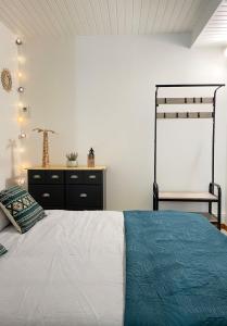 a bedroom with a bed and a dresser at Bienvenue dans le Perche in Sainte-Céronne-lès-Mortagne