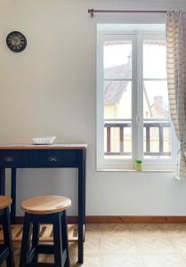 a living room with a fireplace and a window at Bienvenue dans le Perche in Sainte-Céronne-lès-Mortagne