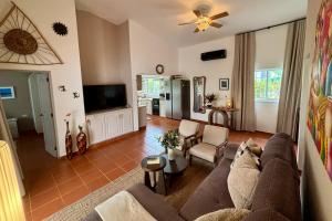 a living room with a couch and a tv at Casa M&B in Las Galeras