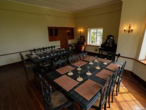 a dining room with a long table and chairs at Graystone Bungalow by Seven Angels in Haputale +49 photos
