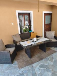 a living room with a table and couches at pasithea mountain rooms in Fylaktí