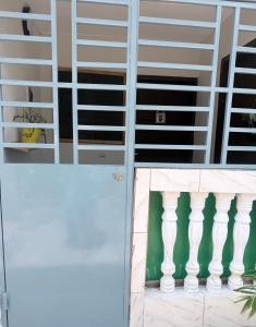 a door to a building with white shutters at Studio Paisible Aéroport FHB in Abidjan