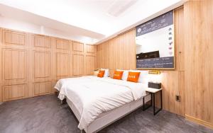 a bedroom with a large bed and a large screen at Instar Hotel in Suwon