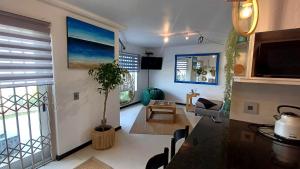 a living room with a couch and a table at Sea Spray Table View Beachfront Bliss in Cape Town