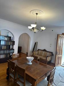 a living room with a wooden table and a couch at Lentexi Inn in Lentekhi