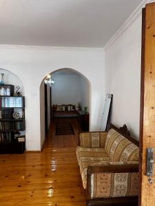 a living room with a couch and a room with a table at Lentexi Inn in Lentekhi +1 photo