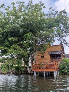 a house on a dock in the water at Studio au bord de la lagune in Assinie +4 photos