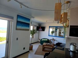 a living room with a view of the ocean at Sea Spray Table View Beachfront Bliss in Cape Town +2 photos