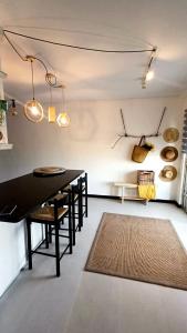 a dining room with a table and chairs and a rug at Sea Spray Table View Beachfront Bliss in Cape Town