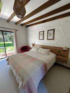 a bedroom with a bed and a large window at Stellamar Apart Hotel in La Serena +40 photos