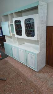 a toy house with two windows in it at Monte Grande Hostel in Monte Grande