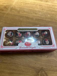 a box of chocolate donuts sitting on a table at Casa Rural La Corrada in Llamoso