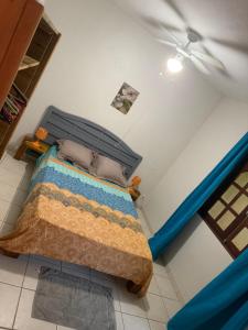 a bedroom with a bed with a blue comforter at Villa Boat red in Quartier Morne Acajou