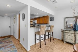 a kitchen with two chairs and a counter in a room at 735 Spinnaker Beach House in Seabrook Island
