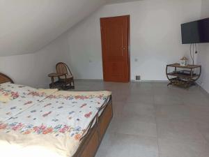 a bedroom with a bed and a flat screen tv at Guest house in Wojtkowa +4 photos