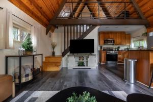 a large living room with a flat screen tv at Hotevilla A-Frame Cabin with Wi-Fi & Pine Tree Views in Flagstaff