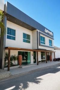 a large white building with a sign on it at Pousada Antonella in Maragogi